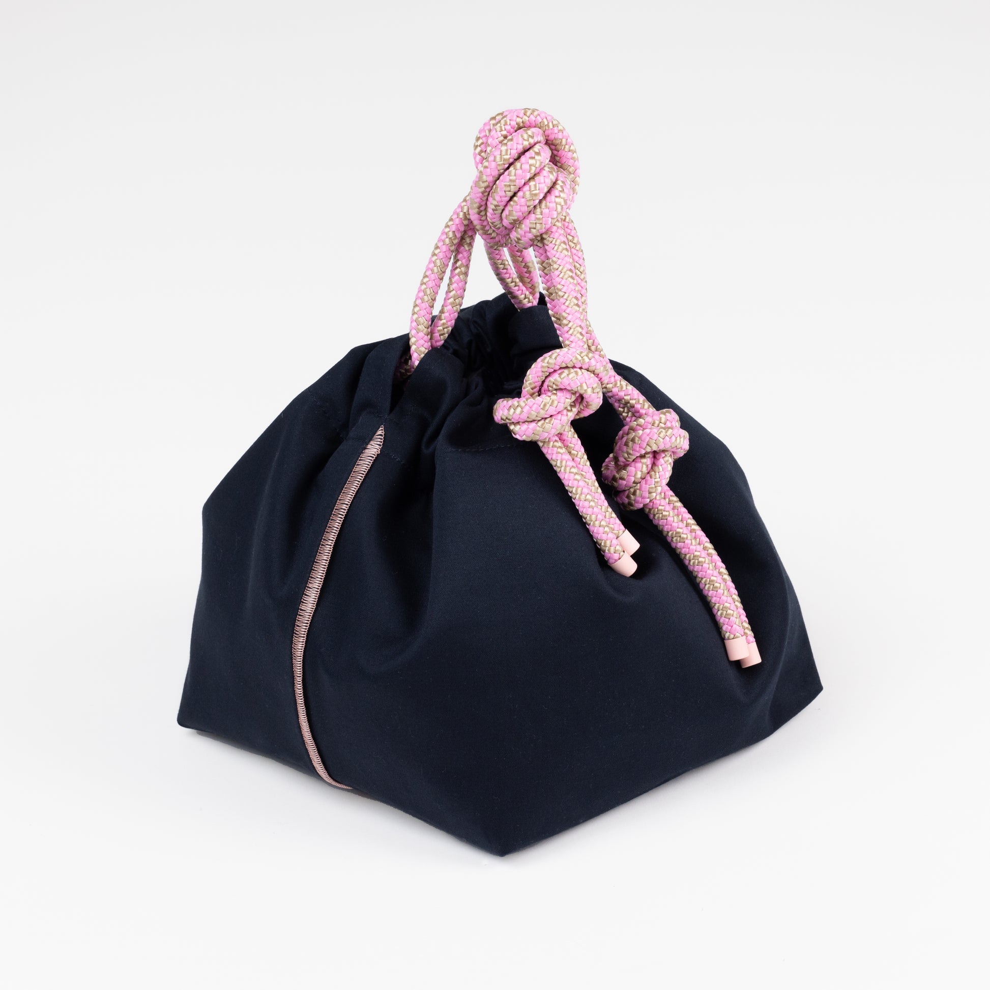 Black drawstring bag with pink rope handles